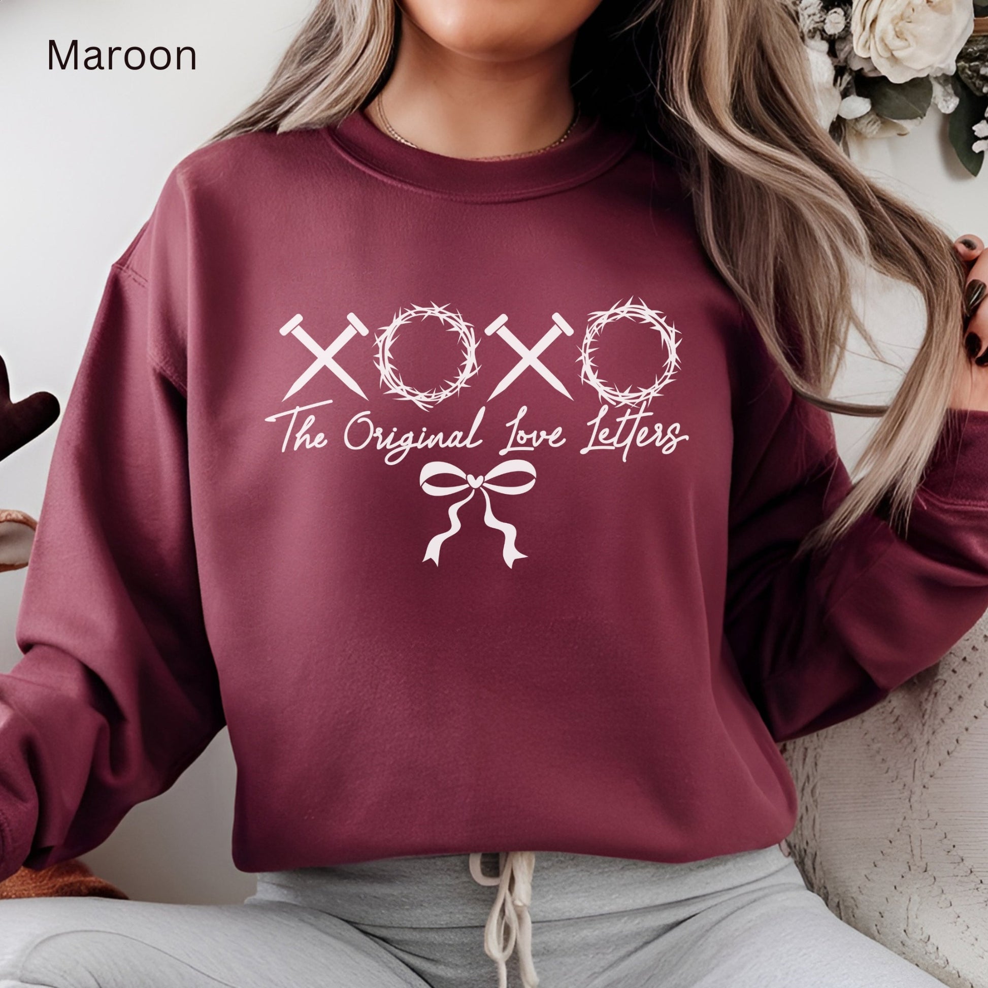 XOXO letters made of spikes and crowns of thorns makes this Jesus sweatshirt say "The Original Love Letter" 