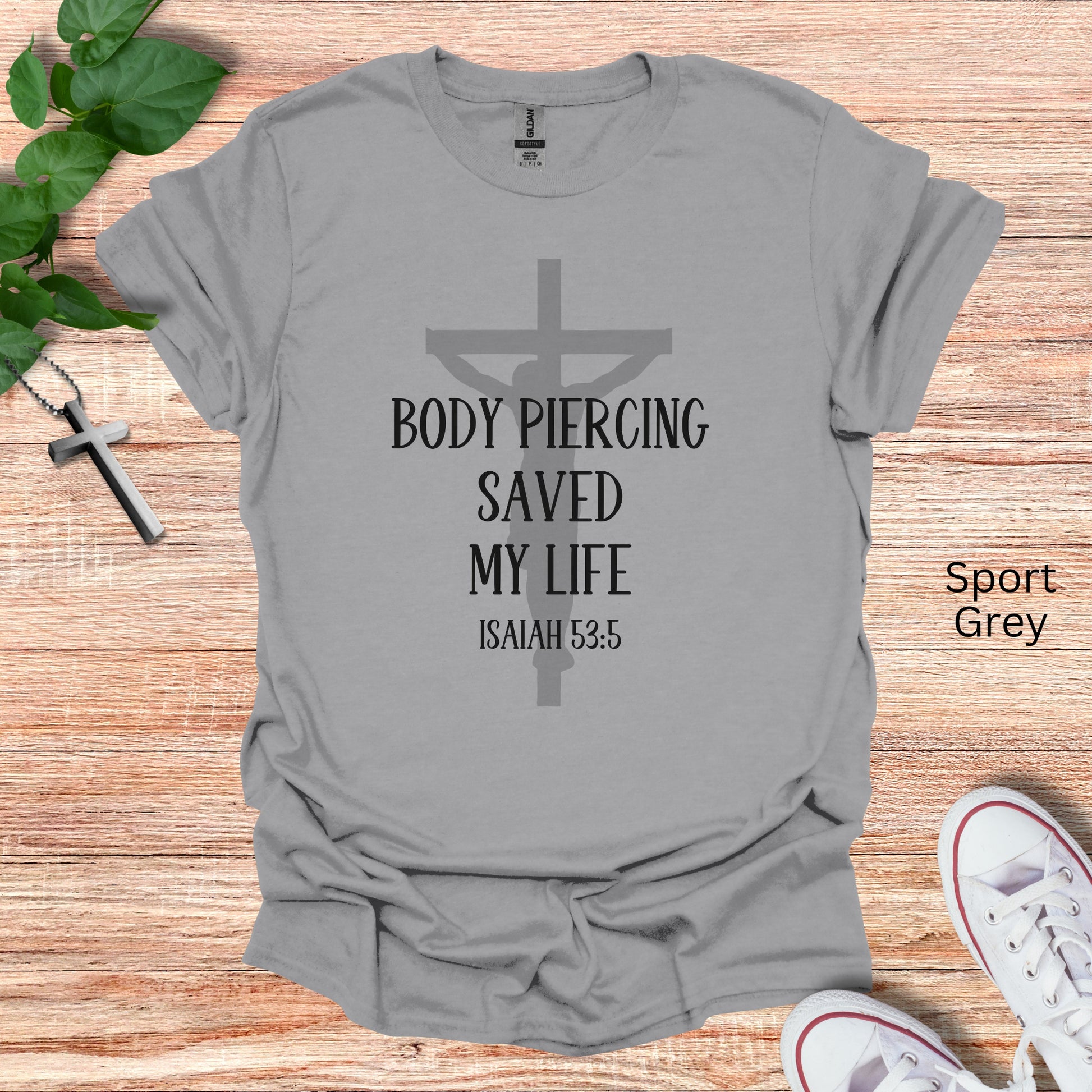 this Christian t-shirt says Body piercing saved my life with a faded crucifix behind noting Isaiah 53:5