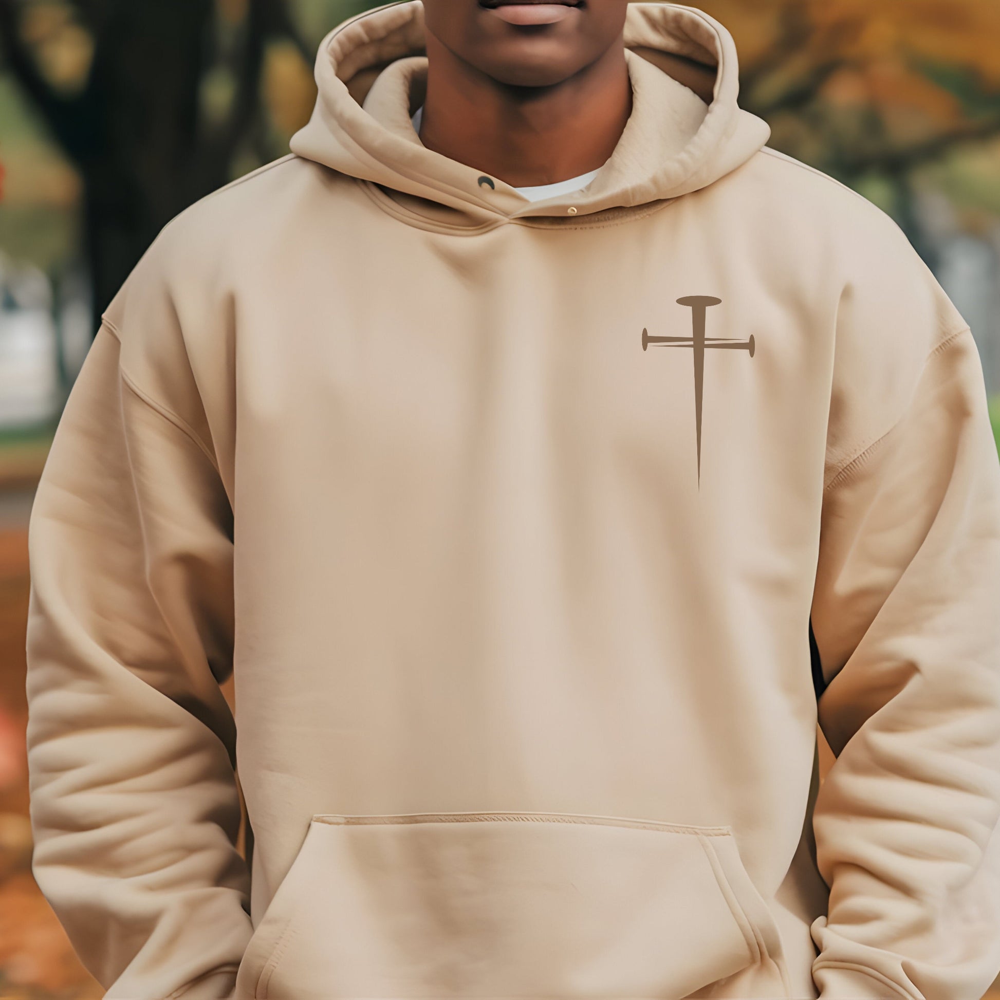 A Christian hoodie with a cross of spikes on front and the Lion of Judah with Revelation 5"5 on back. Shown in sand color. 