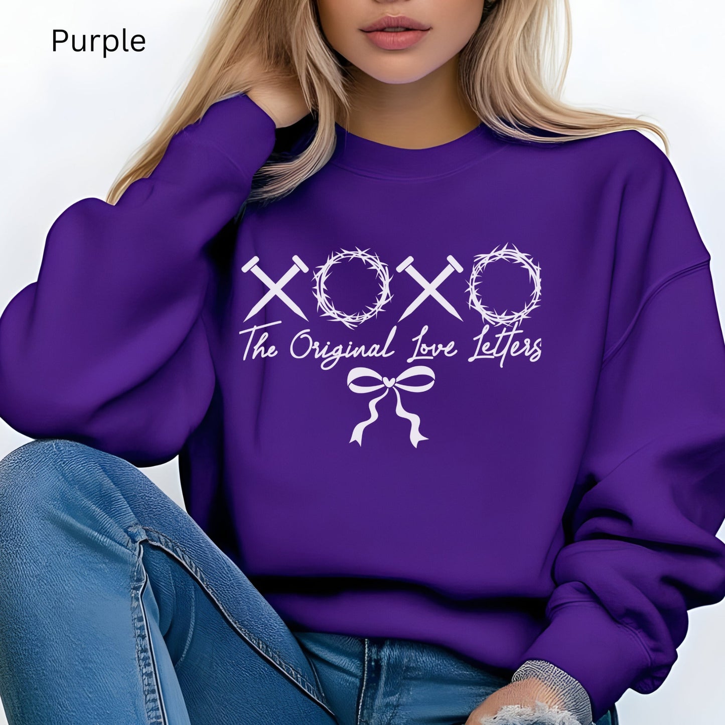 A purple sweatshirt with XOXO made of nails and crowns of thorns says these are the Original Love letters. 