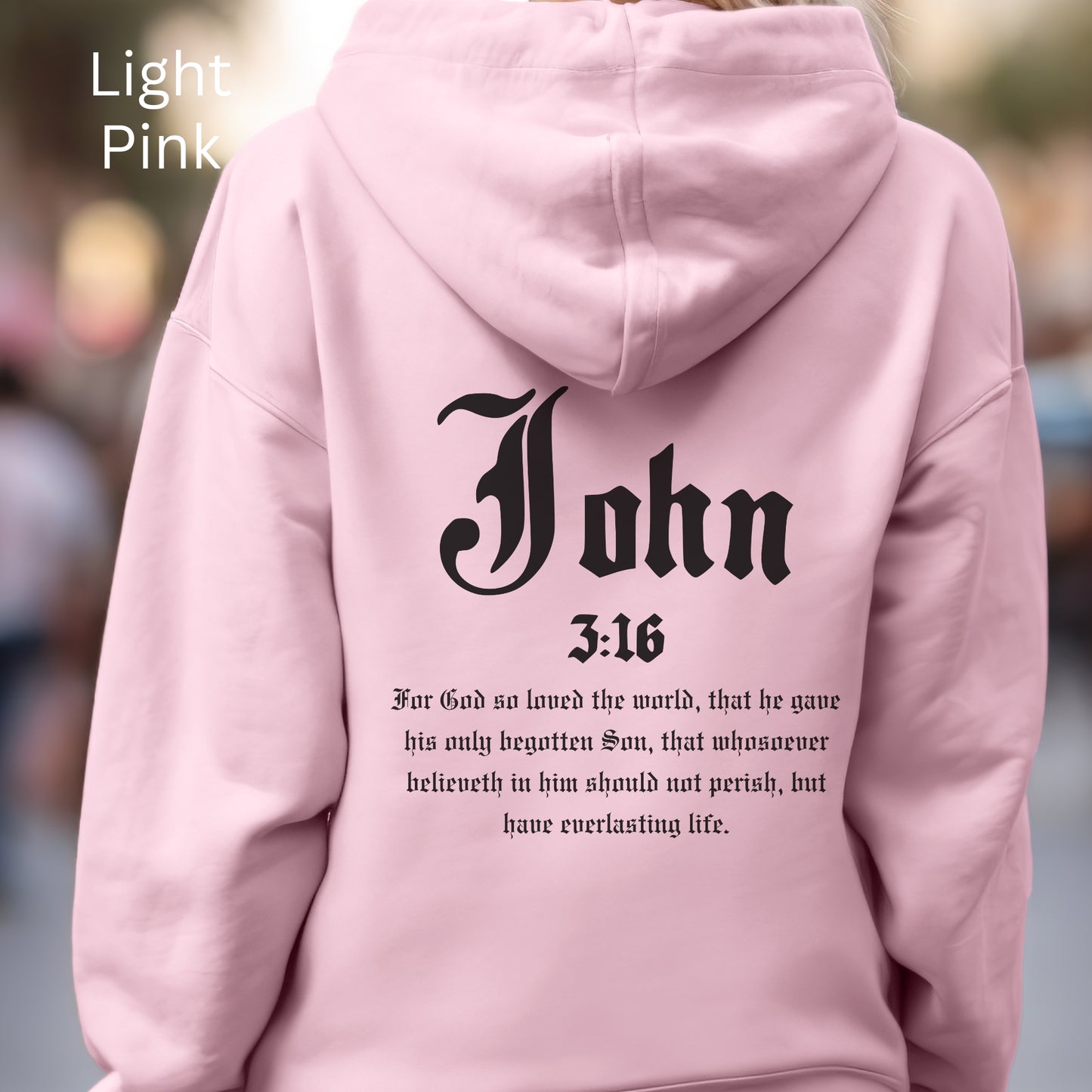 A Christian hoodie sweater gift notes John 3:16 on the back an a cross of nails on the front. Three nails represent the spikes in His hand and feet.