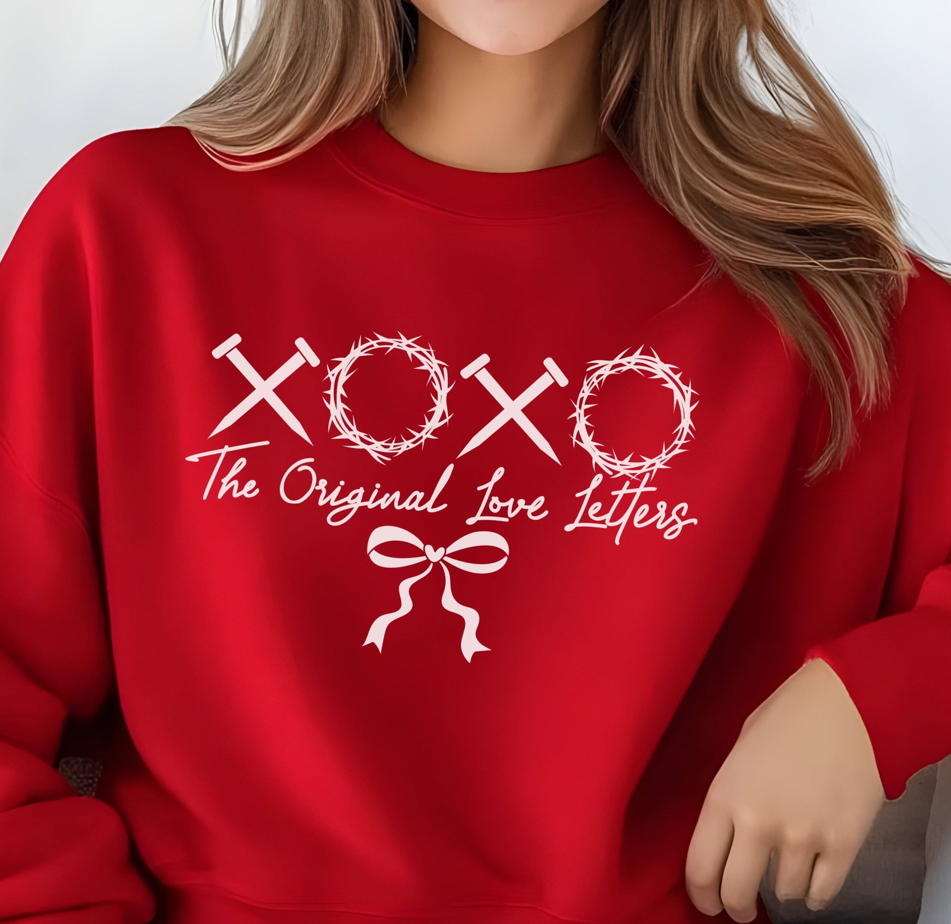 Nails and crowns of thorns symbolizing XOXO make up the graphic on this sweatshirt with the note: the original love letters.